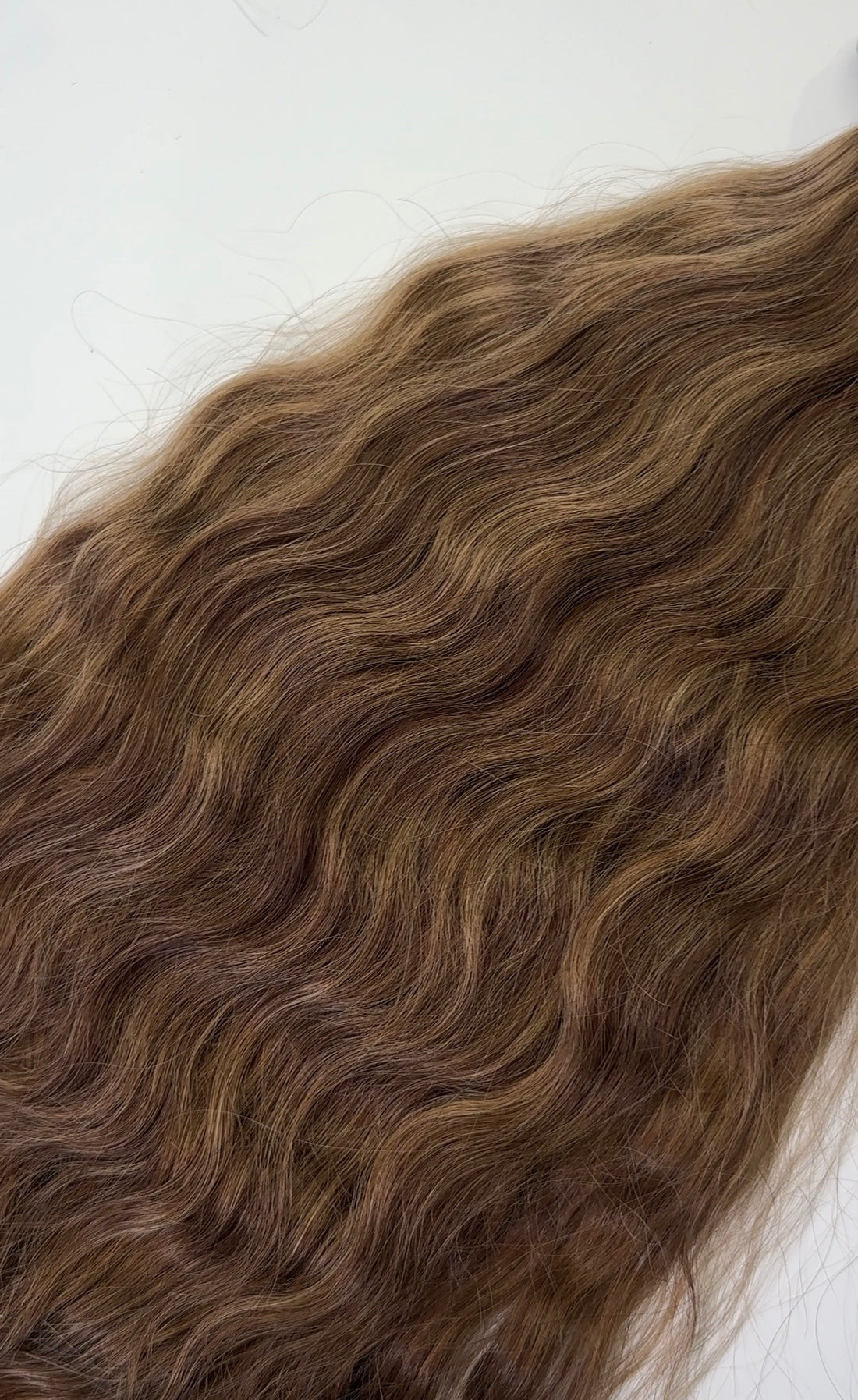 Shade No. 10 natural wavy K-tip hair extensions by Maven & Mane