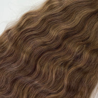 Shade No. 10 natural wavy K-tip hair extensions by Maven & Mane