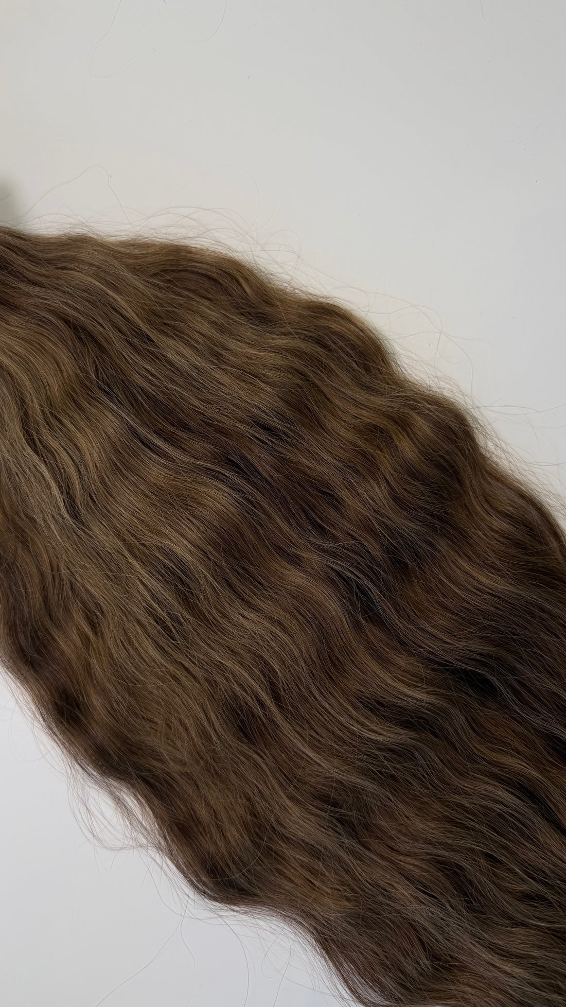 Shade No. 2 natural wavy K-tip hair extensions by Maven & Mane